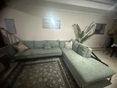 L-shaped light green fabric sofa with chaise - good condition