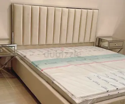 Queen-size upholstered bed with tall vertical-panel headboard (cream), with storage.