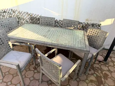 Outdoor 6-Seater Wicker Dining Table with Glass Top and Cushioned Chairs