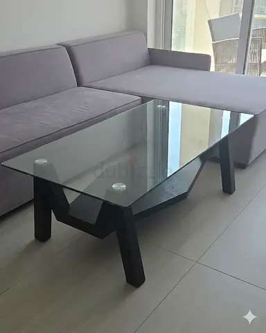Modern glass-top coffee table with black wooden base - good condition
