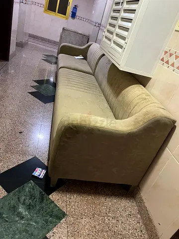 Two-seater beige sofa in good condition