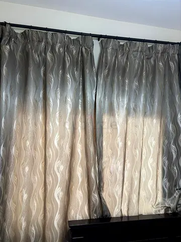 Pair of Gray patterned blackout curtains with rod