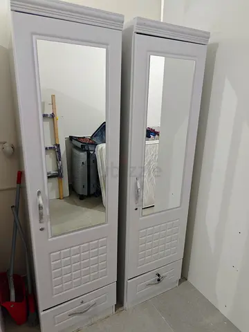 Pair of tall white mirrored wardrobes with drawers