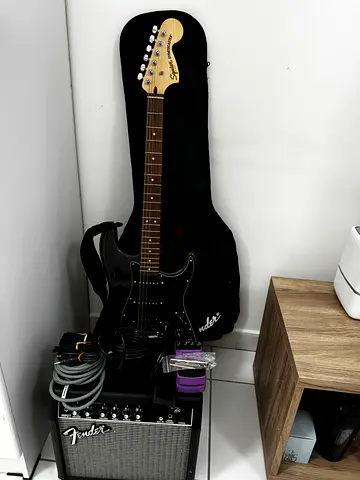Black Fender-style Electric Guitar with Gig Bag and Fender Amp