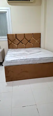 Queen upholstered bed with padded headboard - brown