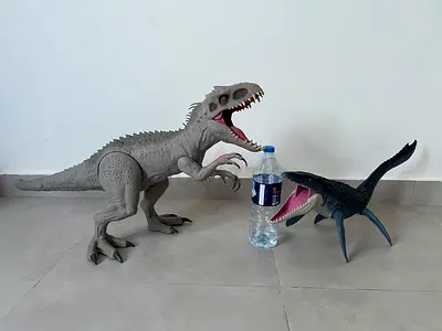 Two dinosaur action figures (large grey theropod + marine reptile)