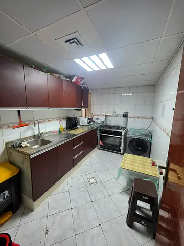 Bed space with a balcony with a fridge