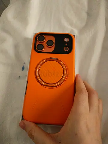 iPhone with orange protective case and ring holder