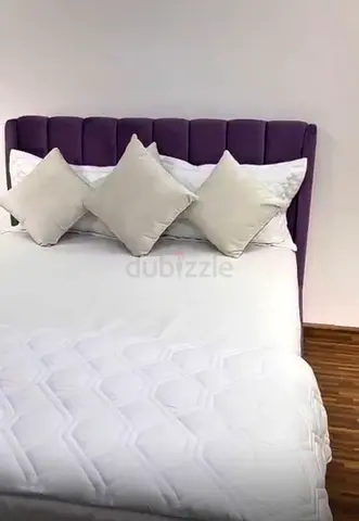 Queen bed with purple upholstered headboard, good condition