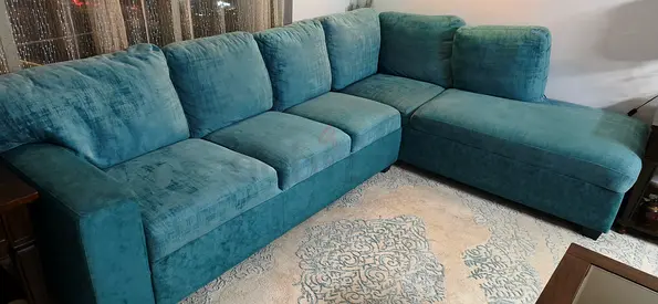 L-shaped teal fabric sofa with chaise