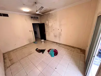 Studio apartment in Al Muwaihat 3, Ajman, with central air conditioning, balcony, and separate kitchen.