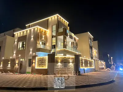Corner villa near Sheikh Mohammed bin Zayed Road and the mall, two floors and a roof, 6 master bedrooms, price includes registration and...