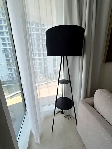 Black tripod floor lamp with small side tables/shelves - modern design