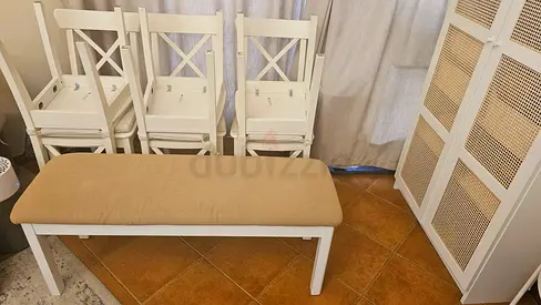 6 White wooden dining chairs with removable beige cushion and 1 wooden bench