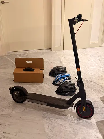 Electric scooter with extra helmets , lightly used Xiaomi-style commuter scooter