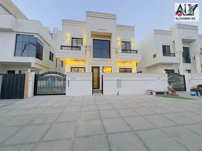 Luxury classic villa for sale in Al Helio area - Ajman, including registration fees, ownership, and electricity and water connections.
