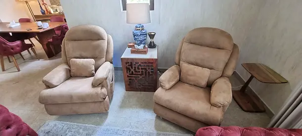 Pair of beige reclining armchairs in good condition