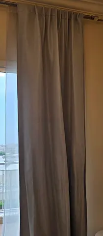 Pair of grey blackout curtains with curtain rod (used)