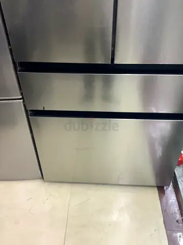 Large stainless steel double-door refrigerator in good condition