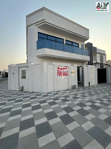 Own a villa in Al Bahia, Ajman, including registration fees, corner of two streets, ground floor, first floor, internal roof, one minute from all serv