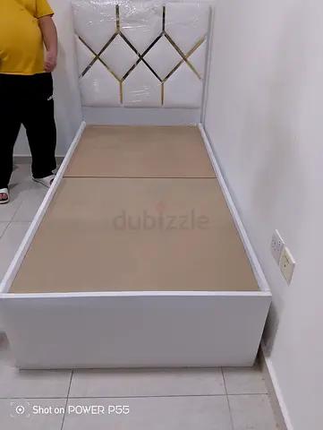 Single white bed frame with padded headboard