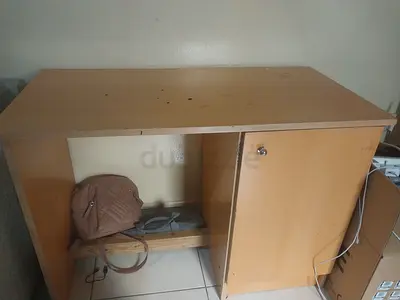 Small wooden storage cabinet with single door and shelf