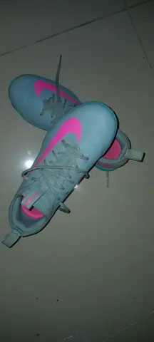 Light blue womens trainers with pink Nike swoosh, gently used