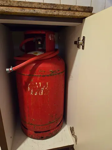 Used LPG Gas Cylinder (Red) with Hose – Good for Home Use