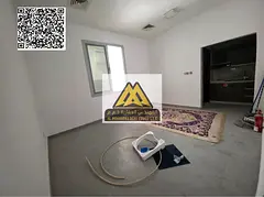 A spacious ground-floor studio for annual rent in Al Rawda 1 – Ajman, featuring a semi-separated k