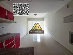 A spacious studio for annual rent in Al Hamidiya – Ajman, featuring a balcony with an open view an