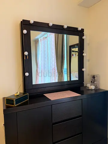 Dresser with sliding mirror