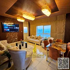 Luxurious two-bedroom apartment with a living room, fully furnished, and featuring a balcony with se