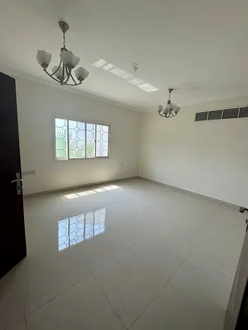 With free parking and a kids' area, a two-bedroom apartment with a living room is available for annual rent in Sharjah, in Al Khan, near the Corniche