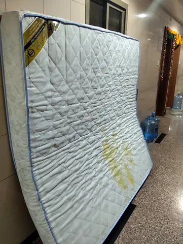 Used double mattress with stains — needs cleaning or reupholster