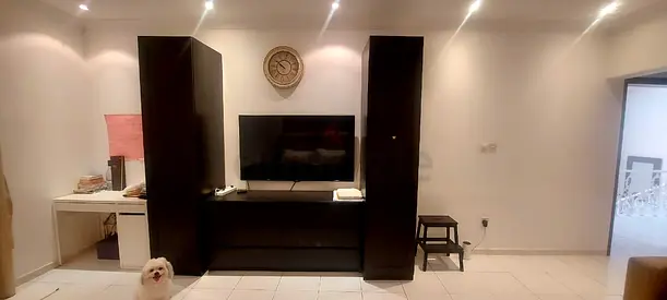 Black wooden TV entertainment center with tall side cabinets