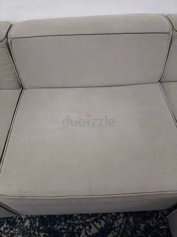 Light grey L-shaped fabric sofa in good used condition