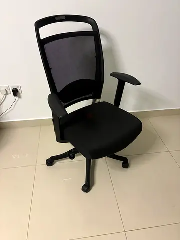 Black ergonomic office chair with mesh back, adjustable armrests