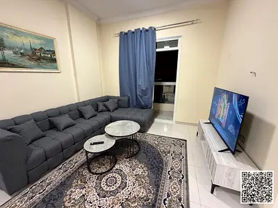 Luxurious two-bedroom apartment with a living room, fully furnished, and featuring a balcony with an open view. Ajman, Al Muwaihat.