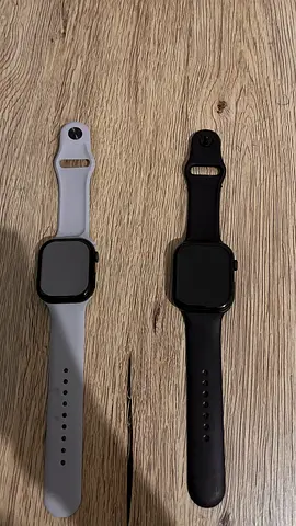 Two smartwatches (used) — one white strap, one black strap