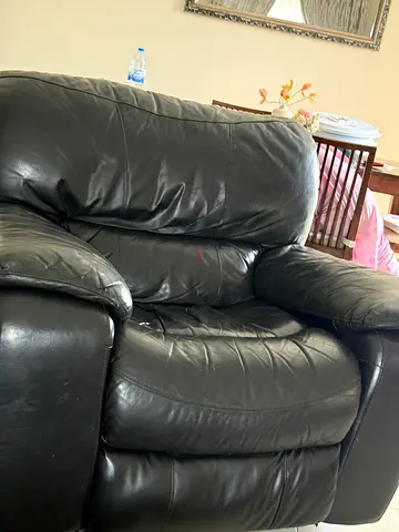 Used black leather 2-seater sofa in good condition