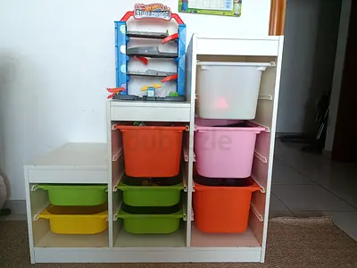 White wooden toy storage unit with 8 colorful bins - good condition