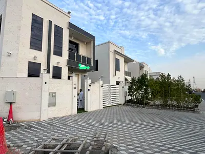 A brand new corner villa for annual rent in Al Yasmin, Ajman, featuring luxurious specifications and high-end finishes. It includes an insulated rooft