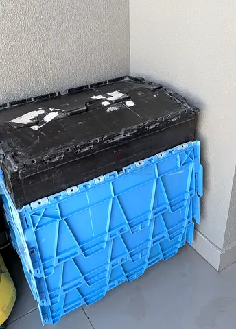 Heavy-duty foldable plastic storage crates with lids.