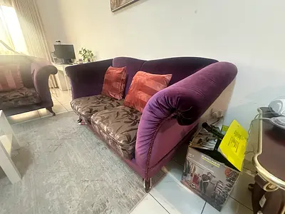Purple velvet 2 and 3 seater sofa with patterned cushions