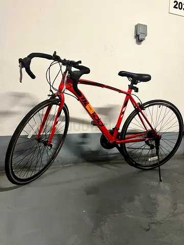 Red road bike with drop handlebars - good working condition