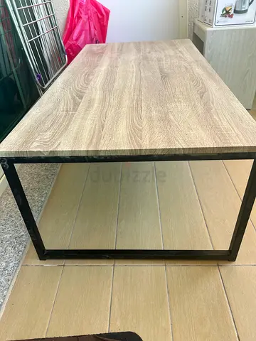 Modern industrial-style wooden coffee table with metal frame