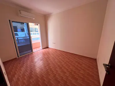 For annual rent in Rawda 2, Ajman, near Kenz Mall - one bedroom and living room - balcony - split A