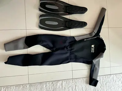 Used full wetsuit with swim fins - size M