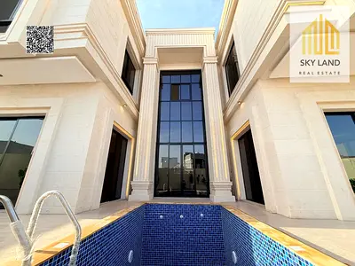 Villa for sale in Al Helio 2, Ajman. 6 master bedrooms with a swimming pool, corner lot facing a garden. Area: 5000 sq ft. Price: AED 3.2 million (inc