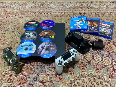 Sony PlayStation 4 Slim bundle with 2 controllers,6 cds,3 cd cover, and doublr charger